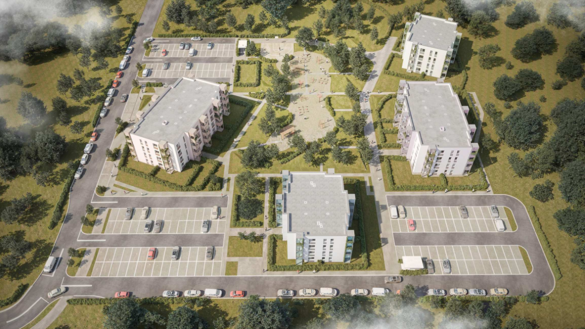 Zdjęcie przedstawia osiedle mieszkaniowe otoczone zielenią